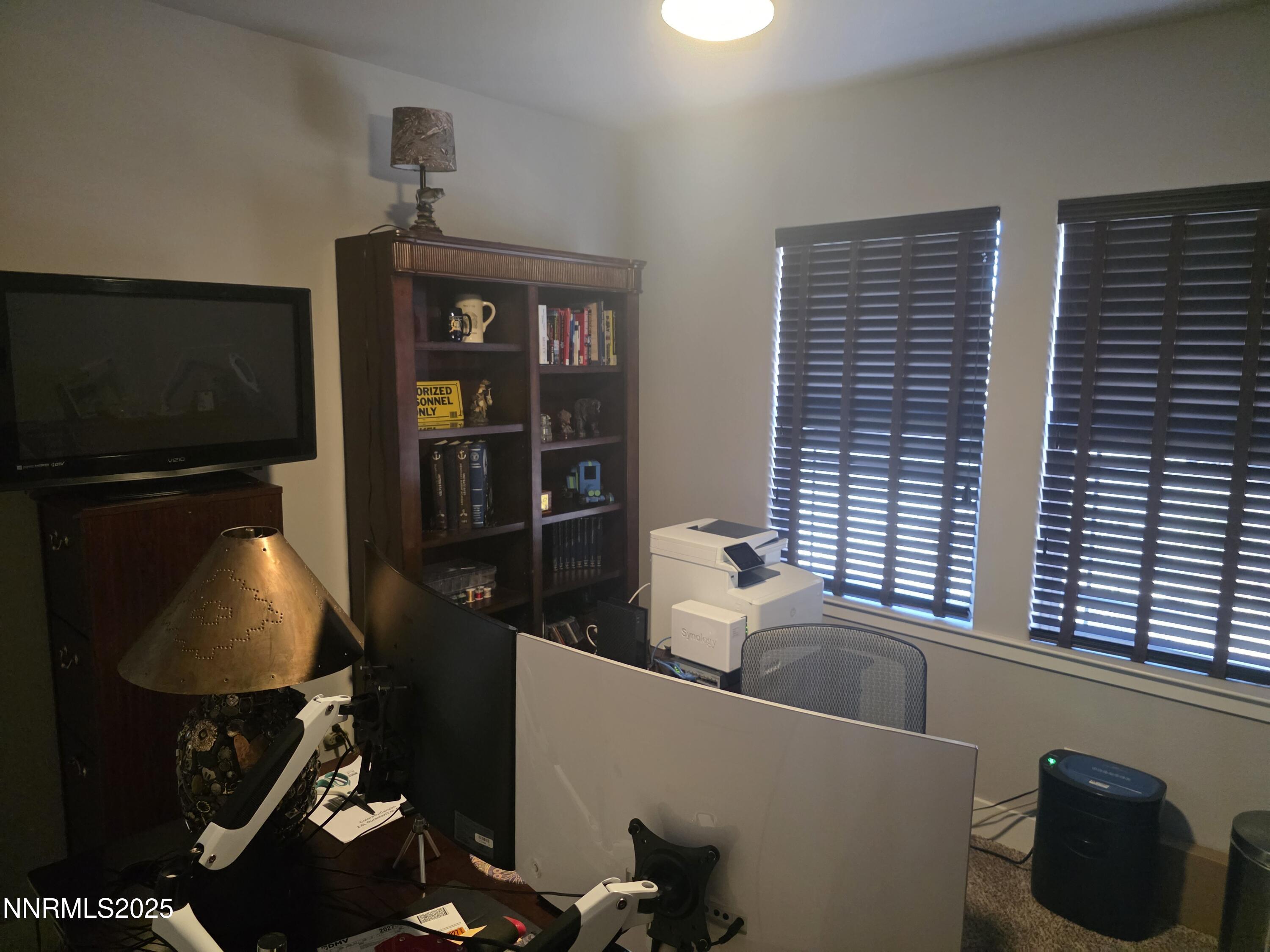 1145 Cheatgrass Drive, Unit BETWEEN DAFFODIL AND ALMOND CREEK Dayton, NV 89403 - Photo 20 of 40 a room with furniture and a flat screen tv