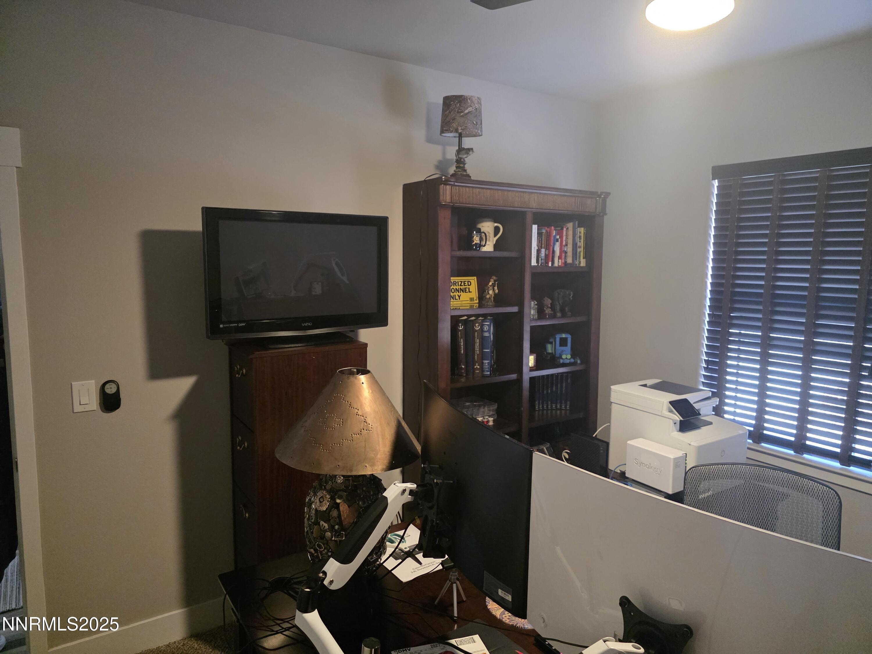 1145 Cheatgrass Drive, Unit BETWEEN DAFFODIL AND ALMOND CREEK Dayton, NV 89403 - Photo 21 of 40 a living room with furniture and a flat screen tv