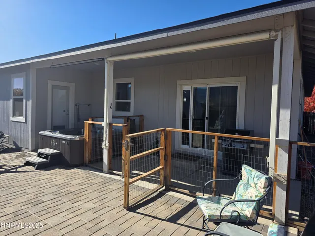 a view of patio with chairs and potted plants