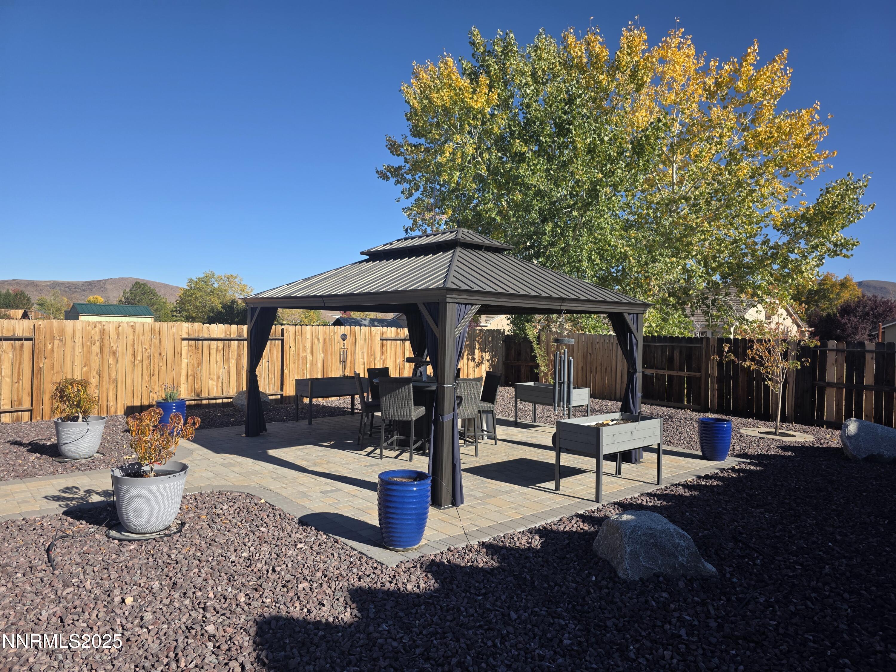 1145 Cheatgrass Drive, Unit BETWEEN DAFFODIL AND ALMOND CREEK Dayton, NV 89403 - Photo 27 of 40 a view of patio with chairs and potted plants