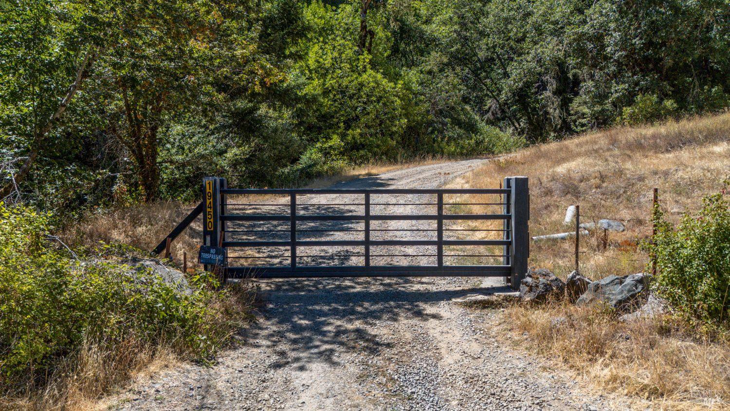 19450 Tomki Road Willits, CA 95490 - Photo 2 of 37 a view of a wooden bench under a large tree