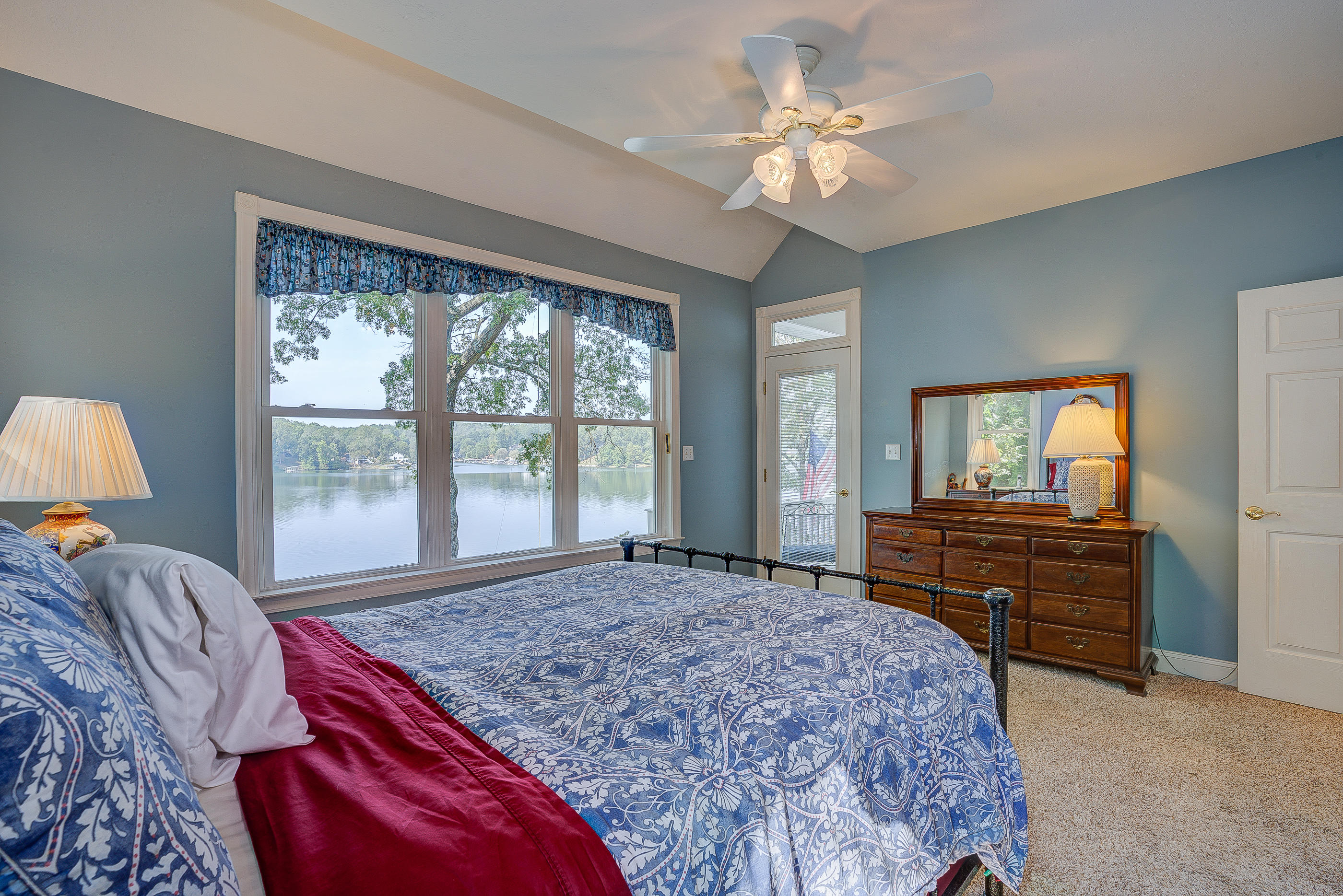 6835 Horseshoe Bend Road Goodview, VA 24095 - Photo 22 of 59 a bedroom with a large bed and a chandelier