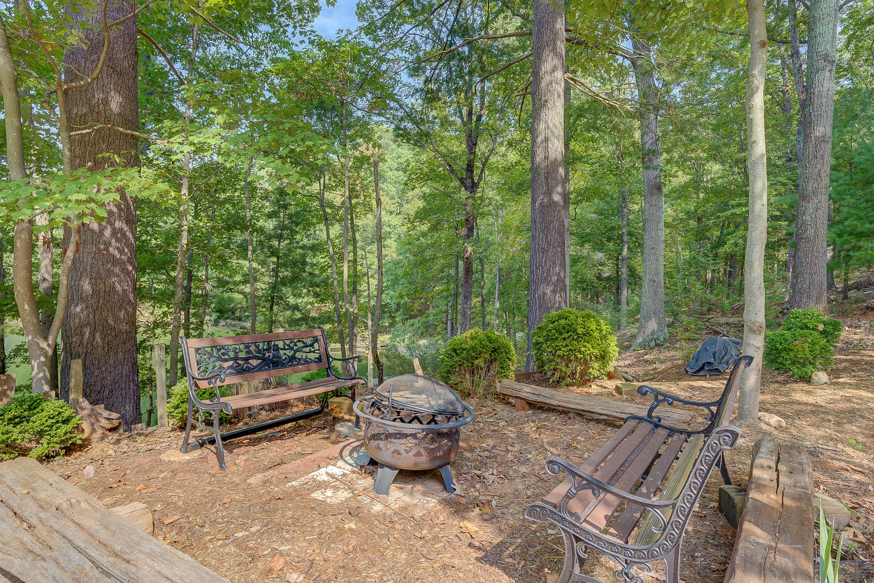 6835 Horseshoe Bend Road Goodview, VA 24095 - Photo 40 of 59 a backyard view with a couple of chairs and a fire pit