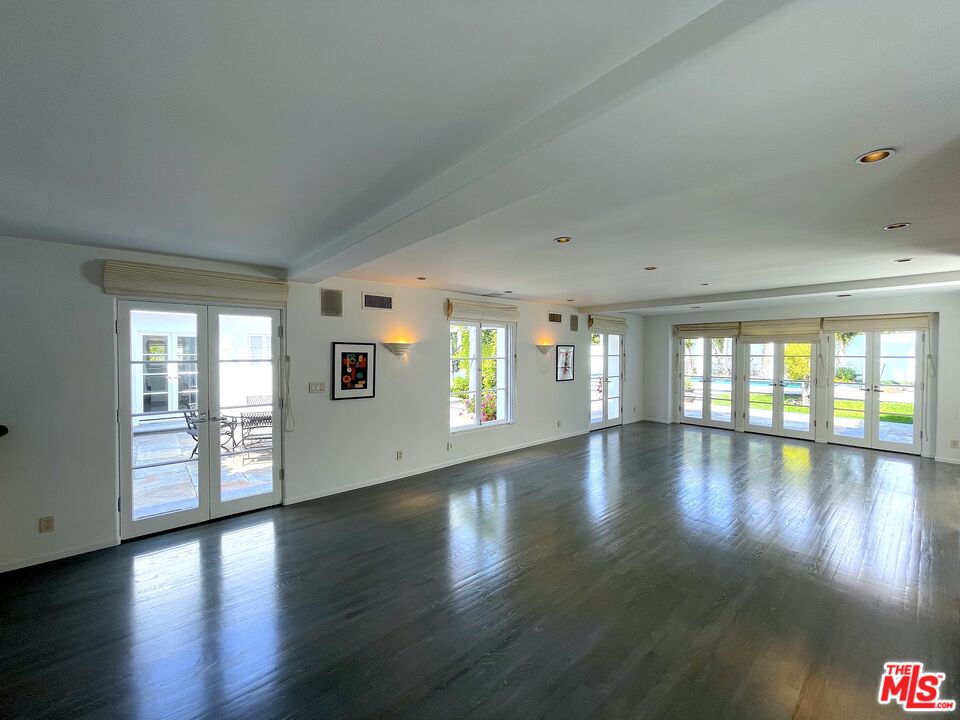 710 Walden Drive Beverly Hills, CA 90210 - Photo 12 of 20 a view of an empty room with wooden floor and a window
