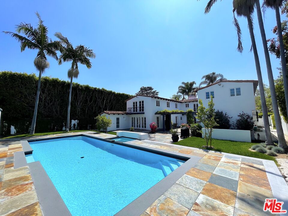 710 Walden Drive Beverly Hills, CA 90210 - Photo 18 of 20 a view of a swimming pool with a patio