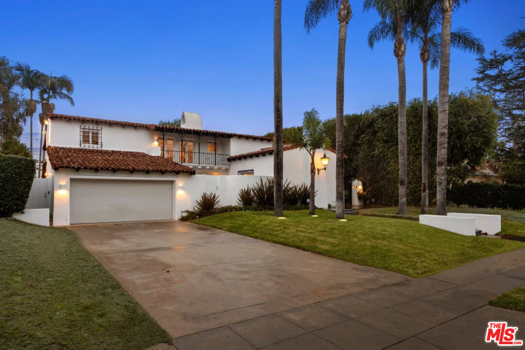 710 Walden Drive Beverly Hills, CA 90210 - Photo 2 of 20 a front view of a house with a yard and garage