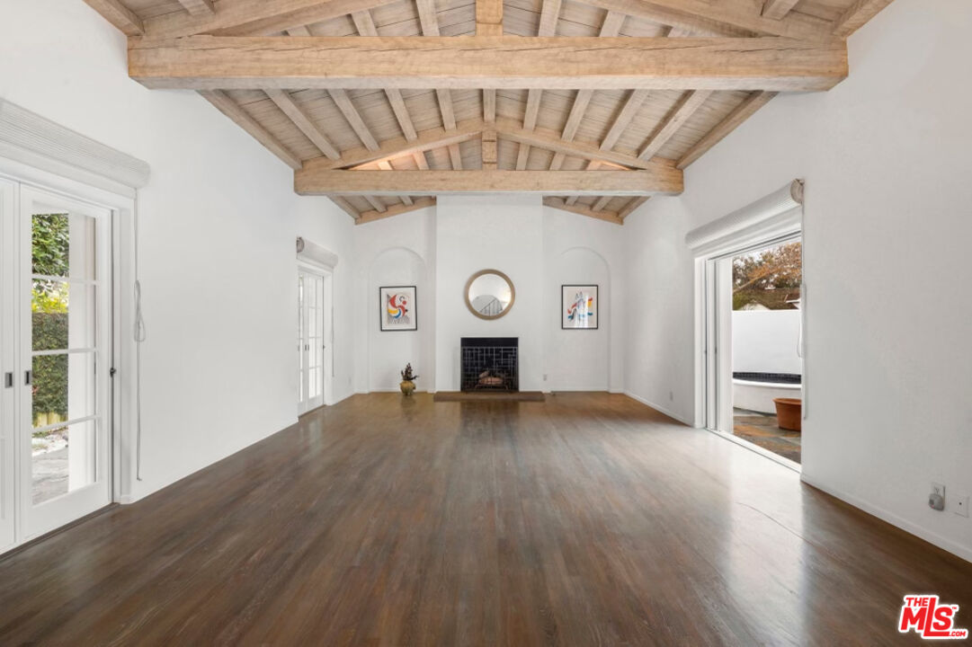 710 Walden Drive Beverly Hills, CA 90210 - Photo 6 of 20 a view of a livingroom with wooden floor and a fireplace