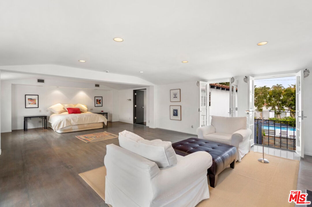 710 Walden Drive Beverly Hills, CA 90210 - Photo 9 of 20 a bedroom with a bed and a large window