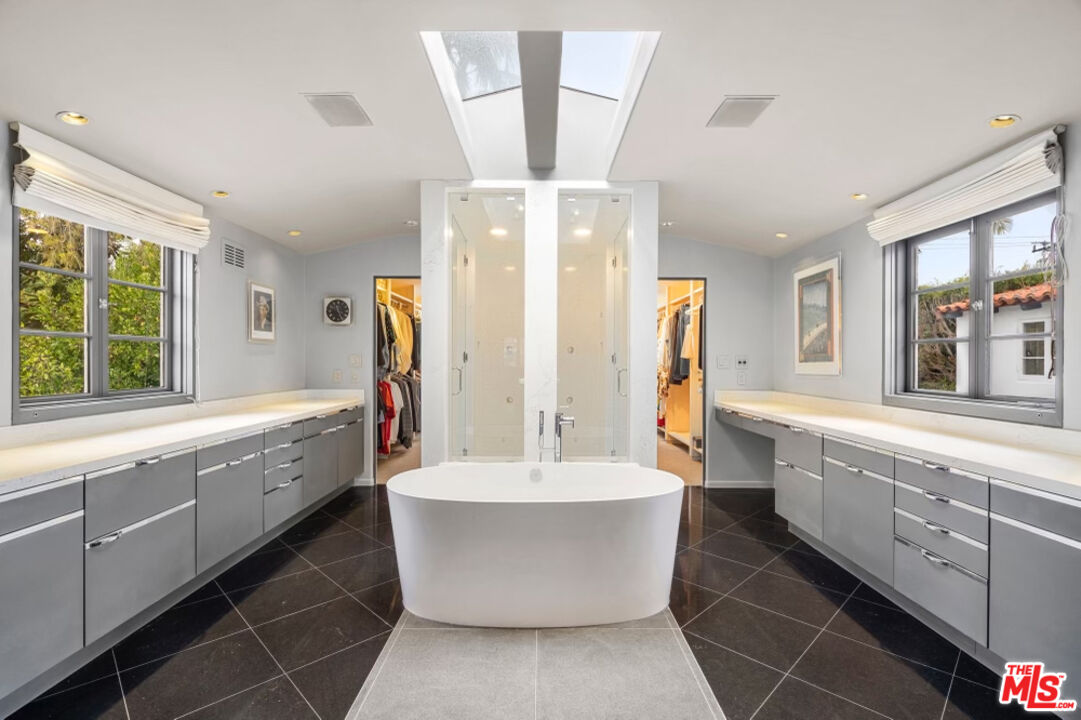 710 Walden Drive Beverly Hills, CA 90210 - Photo 10 of 20 a large bathroom with a bathtub and double sink