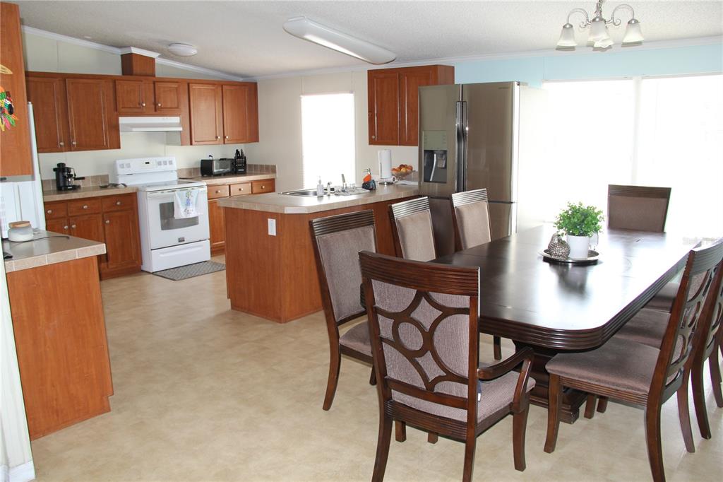 13127 Star Road Brooksville, FL 34613 - Photo 9 of 54 a view of kitchen with dining table and chairs