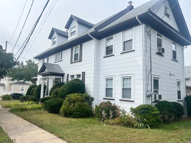 a view of a house with a yard and plants