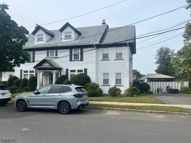 a view of a car parked in front of a house