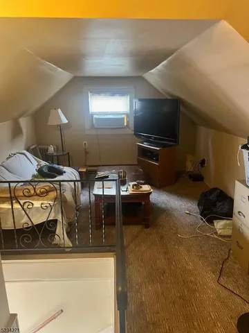 a living room with chairs and a flat screen tv