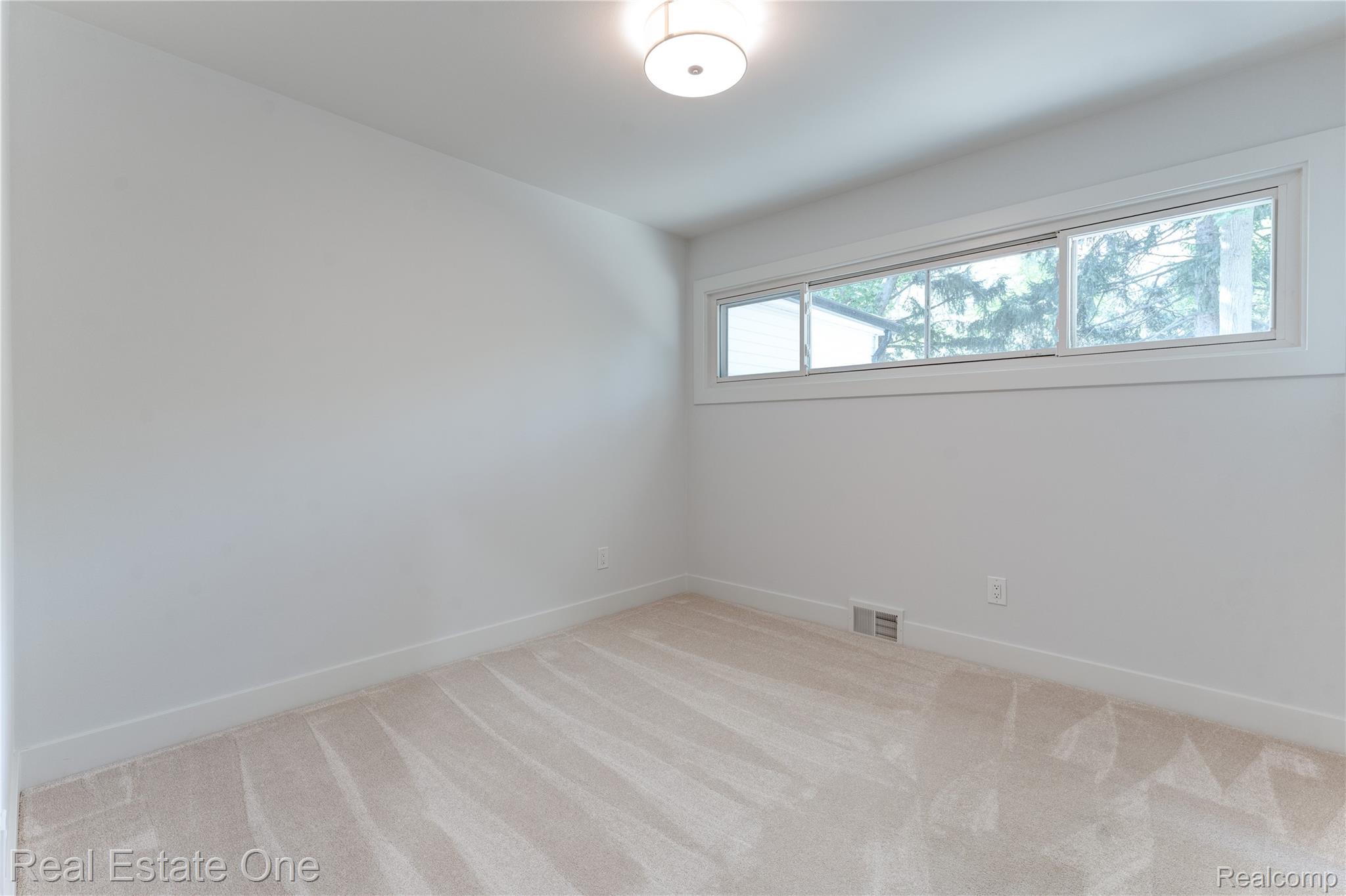 786 South Cranbrook Road Bloomfield Hills, MI 48301 - Photo 13 of 38 Unfurnished room with light carpet and baseboards
