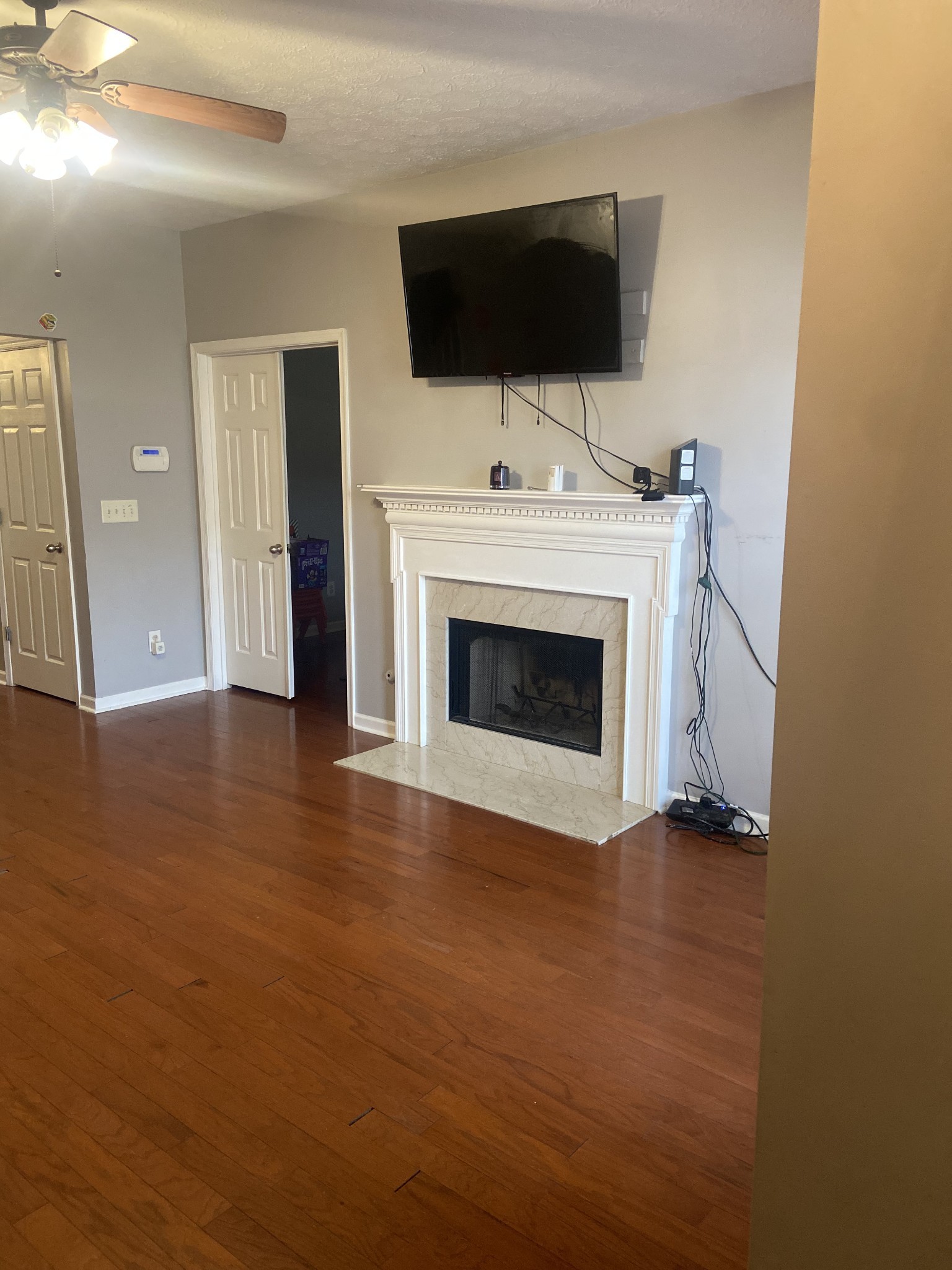 1660 Comanche Run Madison, TN 37115 - Photo 6 of 28 a living room with a fireplace and a flat screen tv