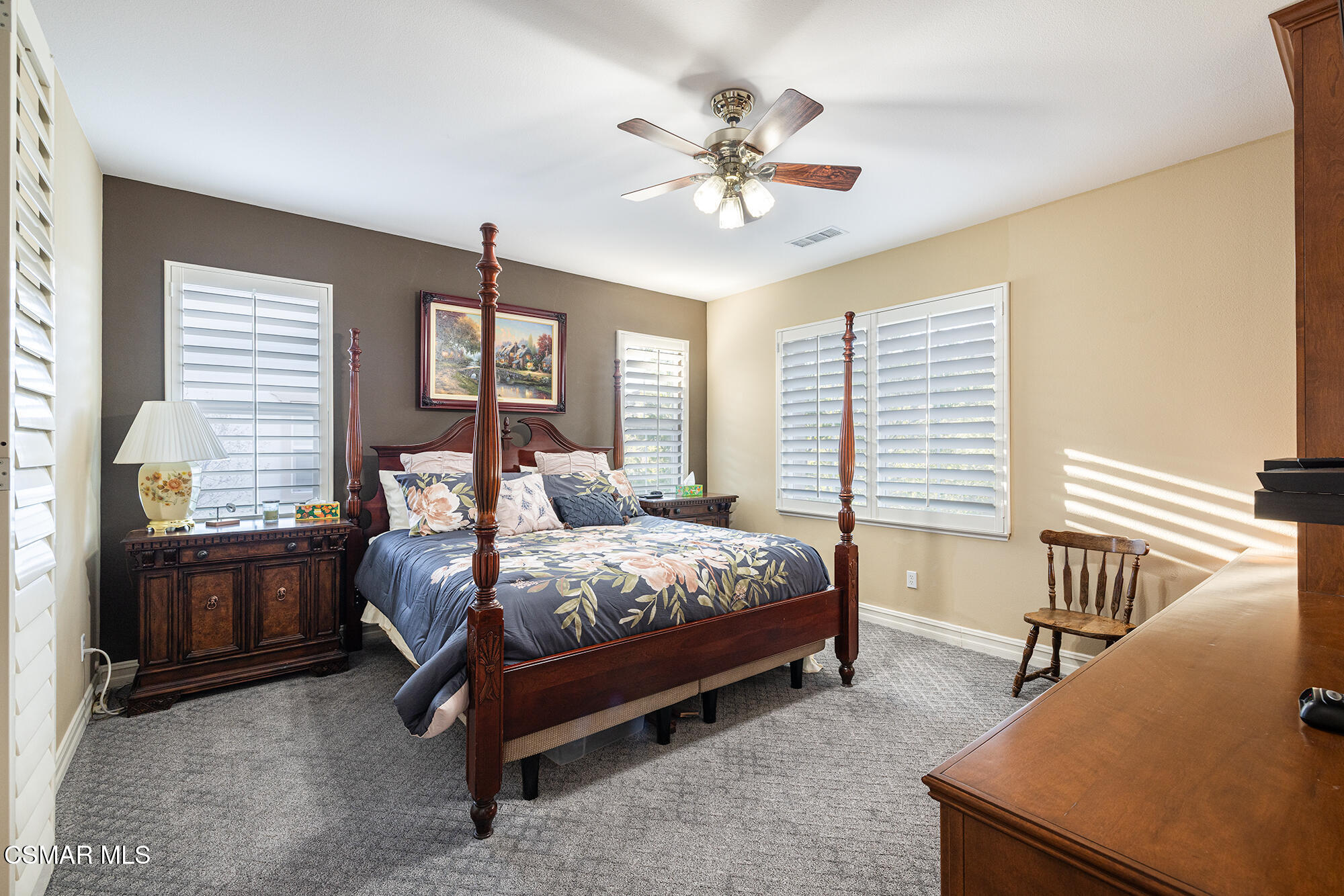 5019 Corral Street Simi Valley, CA 93063 - Photo 18 of 50 a bedroom with a bed and a chandelier