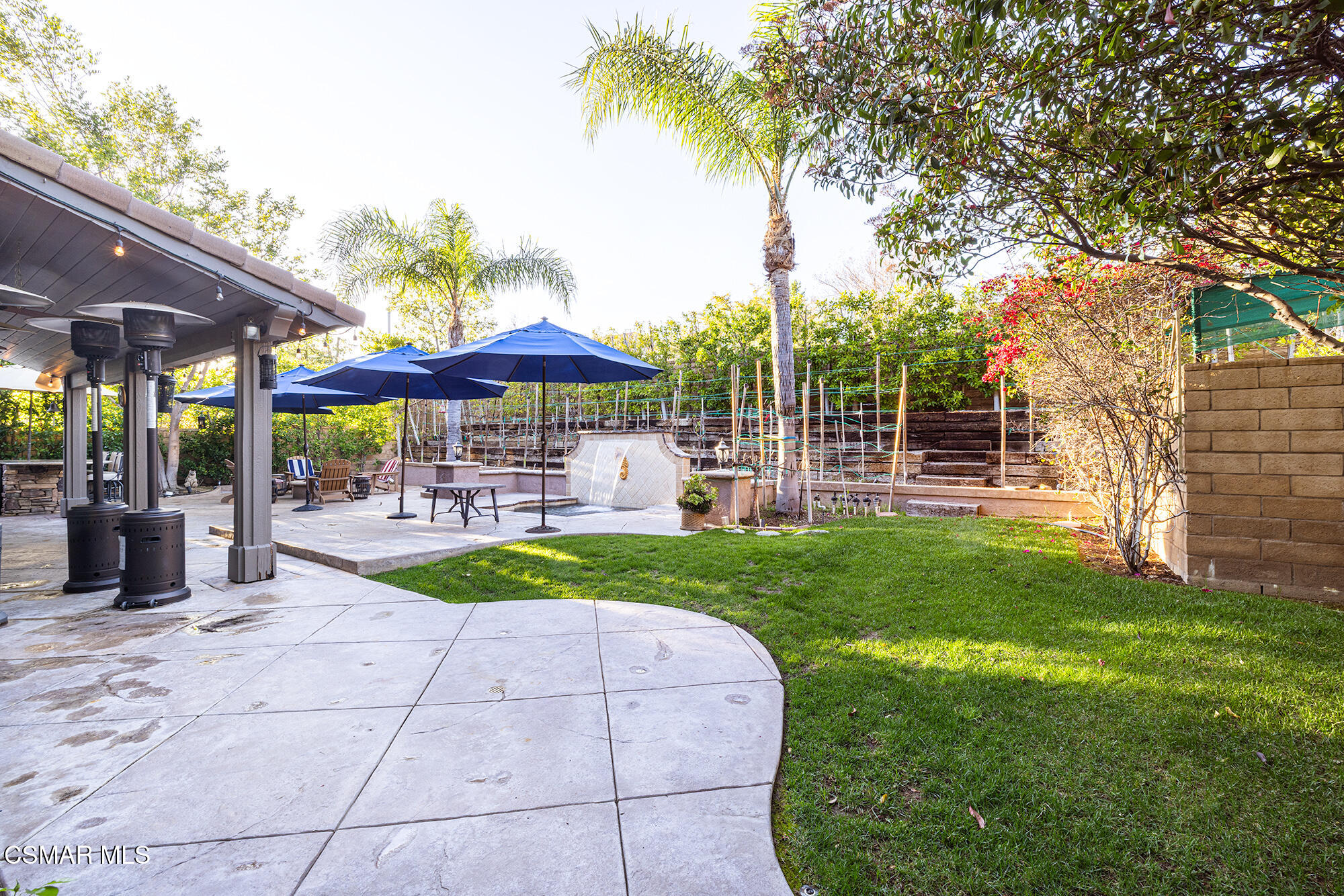 5019 Corral Street Simi Valley, CA 93063 - Photo 35 of 50 a view of a patio with a table and chairs under an umbrella