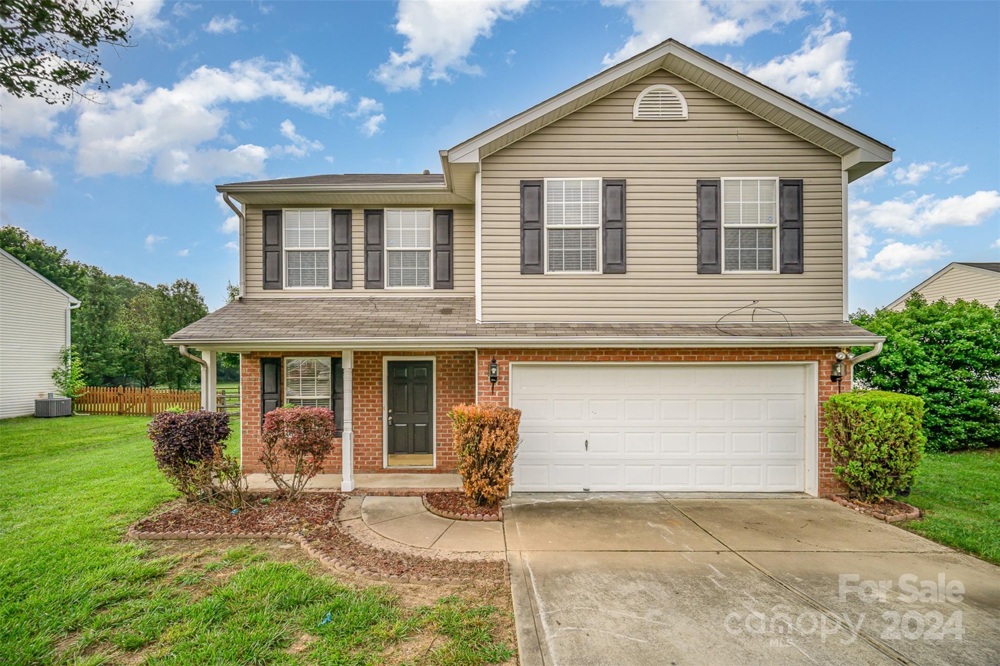 5018 Revelation Way Monroe, NC 28110 - Photo 1 of 19 a front view of a house with garden