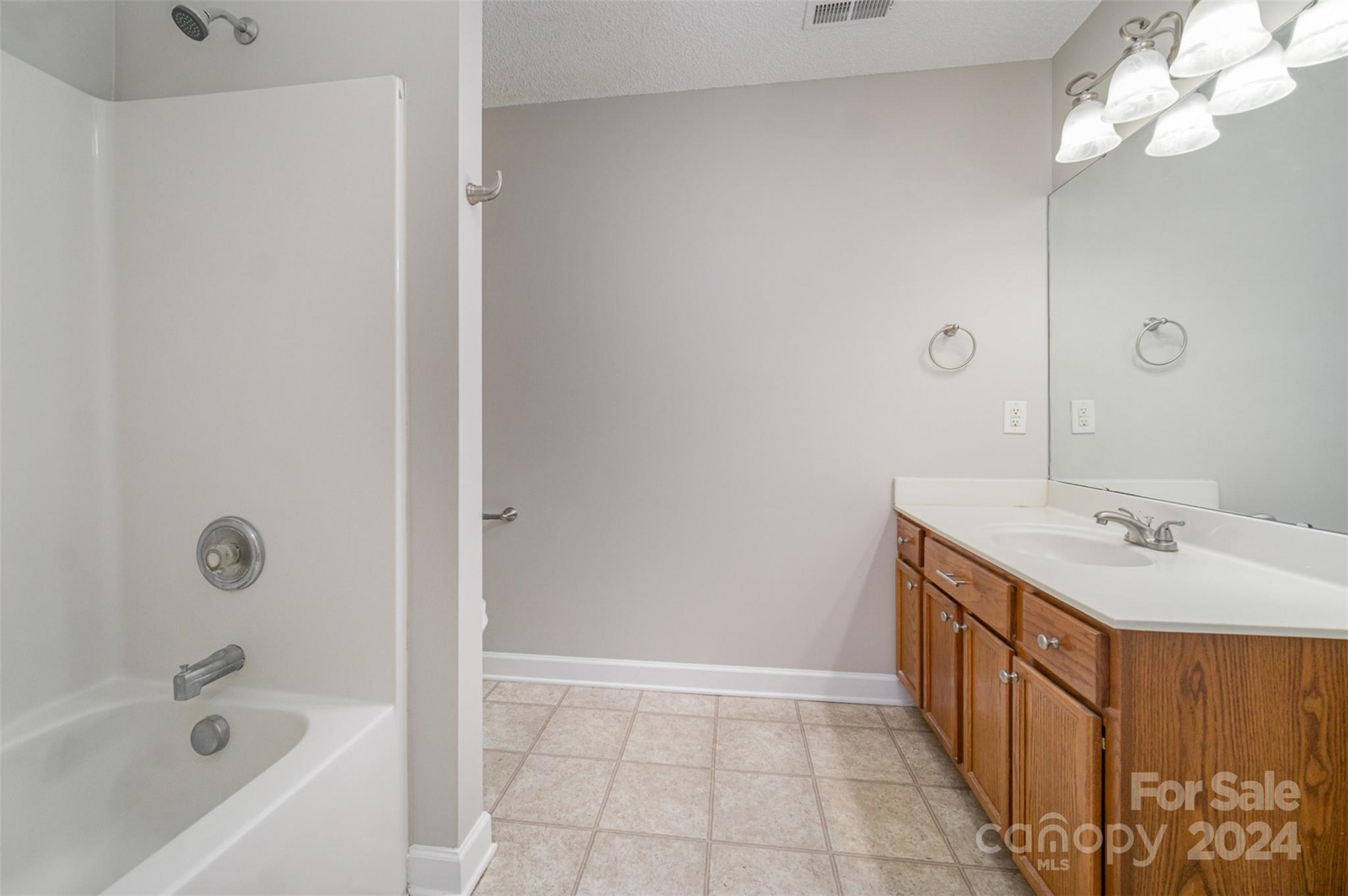 5018 Revelation Way Monroe, NC 28110 - Photo 12 of 19 a bathroom with a tub sink and mirror