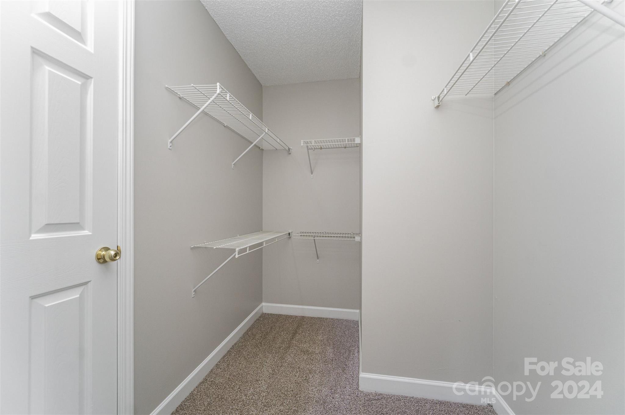 5018 Revelation Way Monroe, NC 28110 - Photo 13 of 19 a view of an empty walk in closet