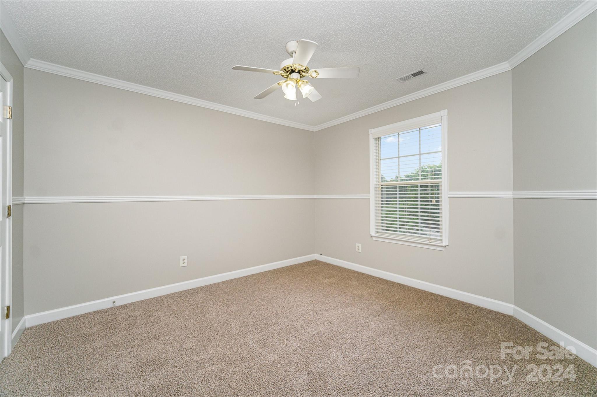 5018 Revelation Way Monroe, NC 28110 - Photo 15 of 19 an empty room with a window and a ceiling fan