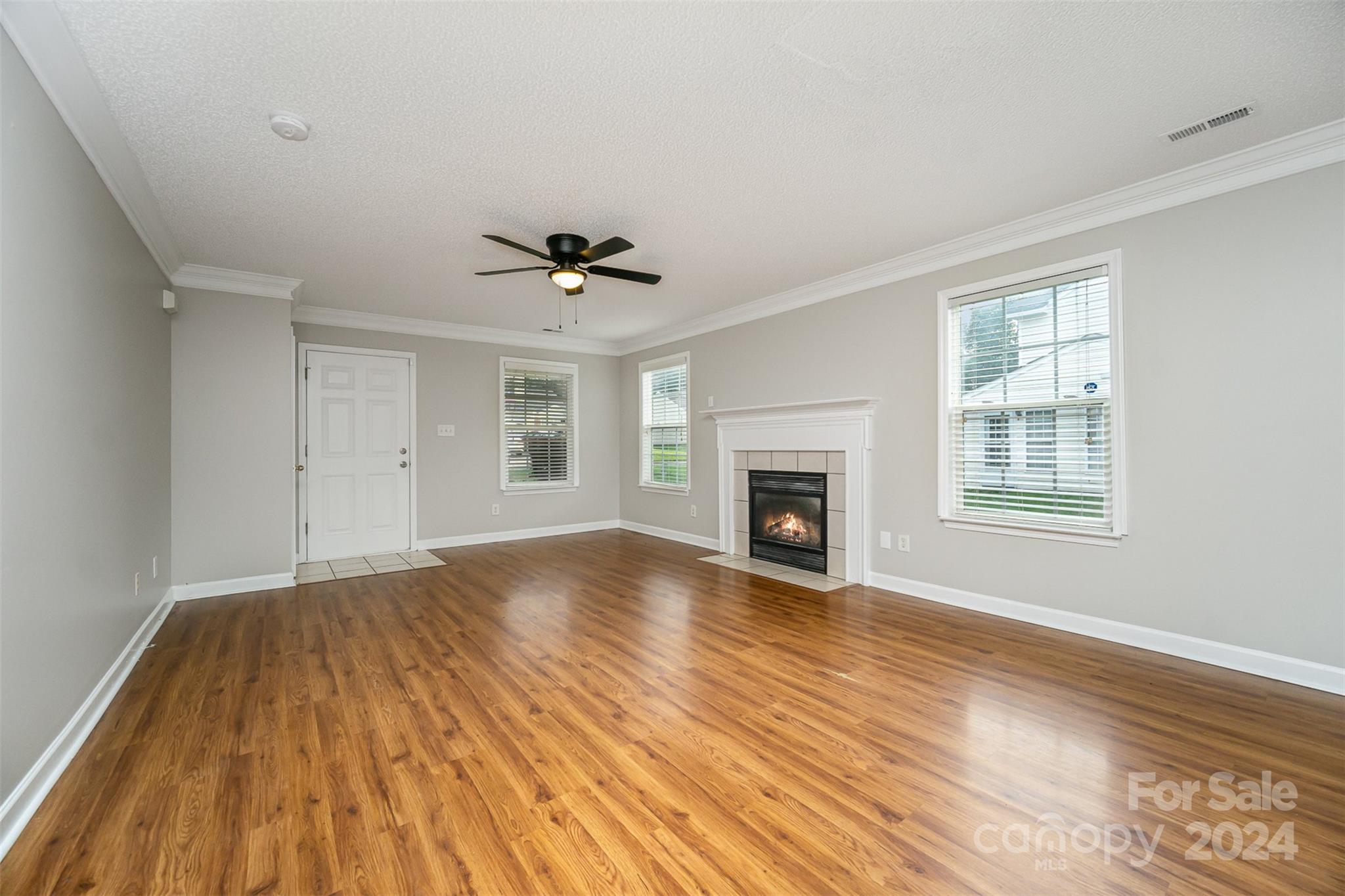 5018 Revelation Way Monroe, NC 28110 - Photo 2 of 19 a view of an empty room with wooden floor and a window