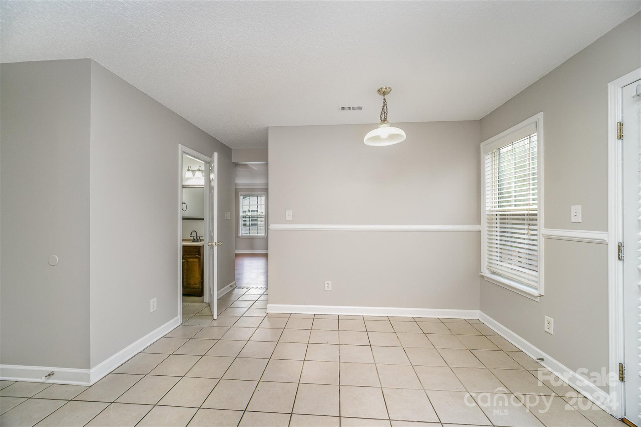 5018 Revelation Way Monroe, NC 28110 - Photo 6 of 19 a view of an empty room with window and chandelier fan