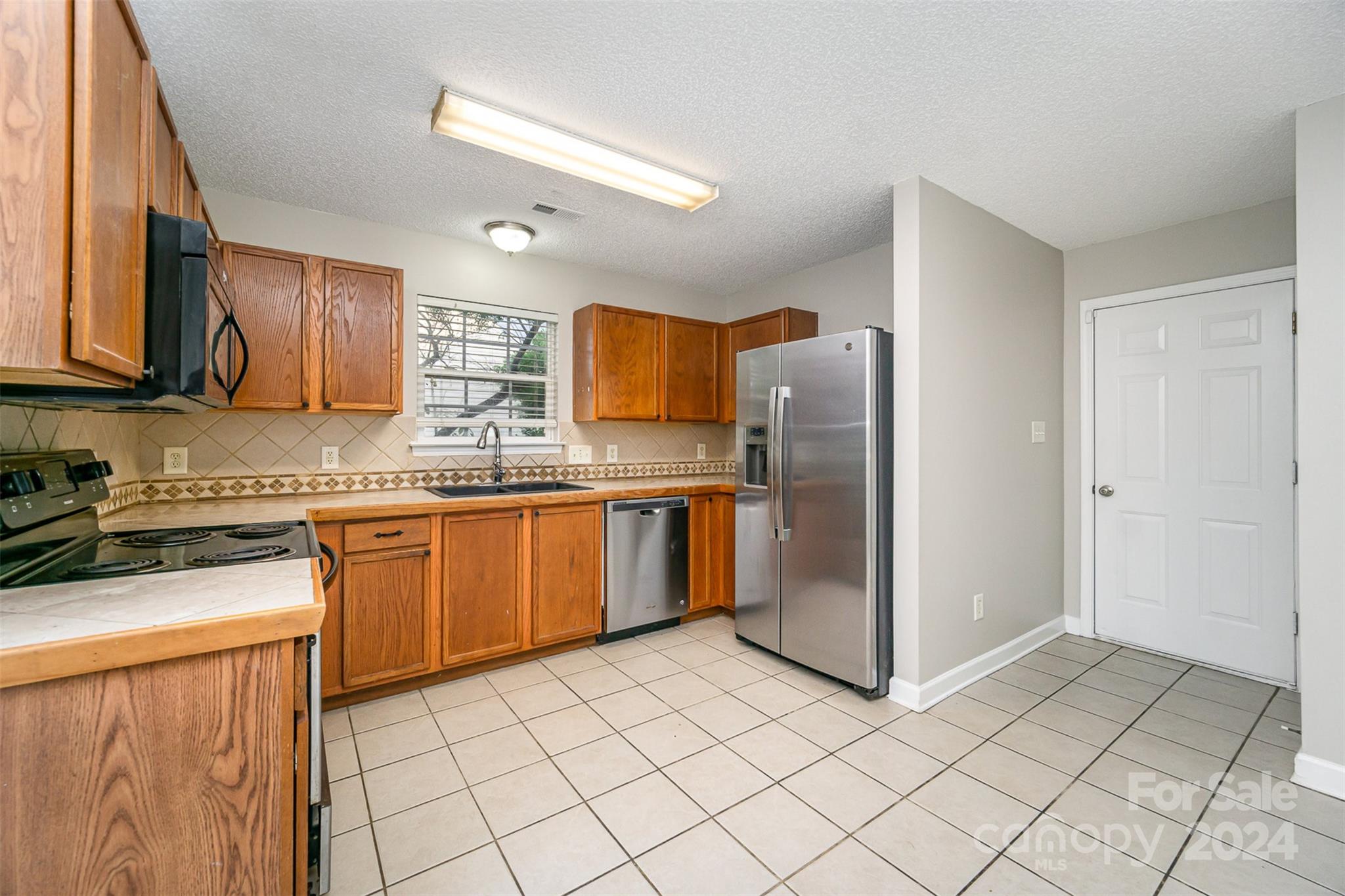 5018 Revelation Way Monroe, NC 28110 - Photo 8 of 19 a kitchen with stainless steel appliances granite countertop a refrigerator and a stove top oven