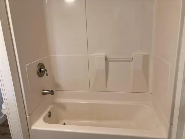 a view of a room that has wooden floor and large window