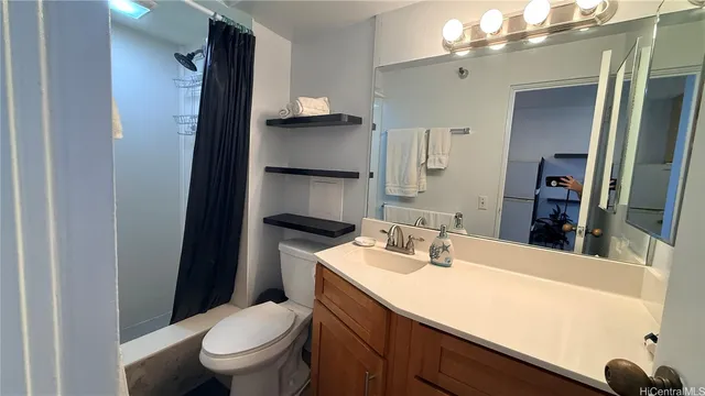 a bathroom with a sink a toilet and a mirror