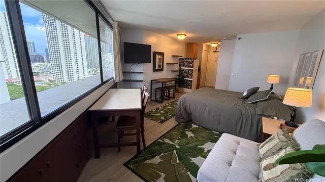 a view of a livingroom with furniture and a flat screen tv