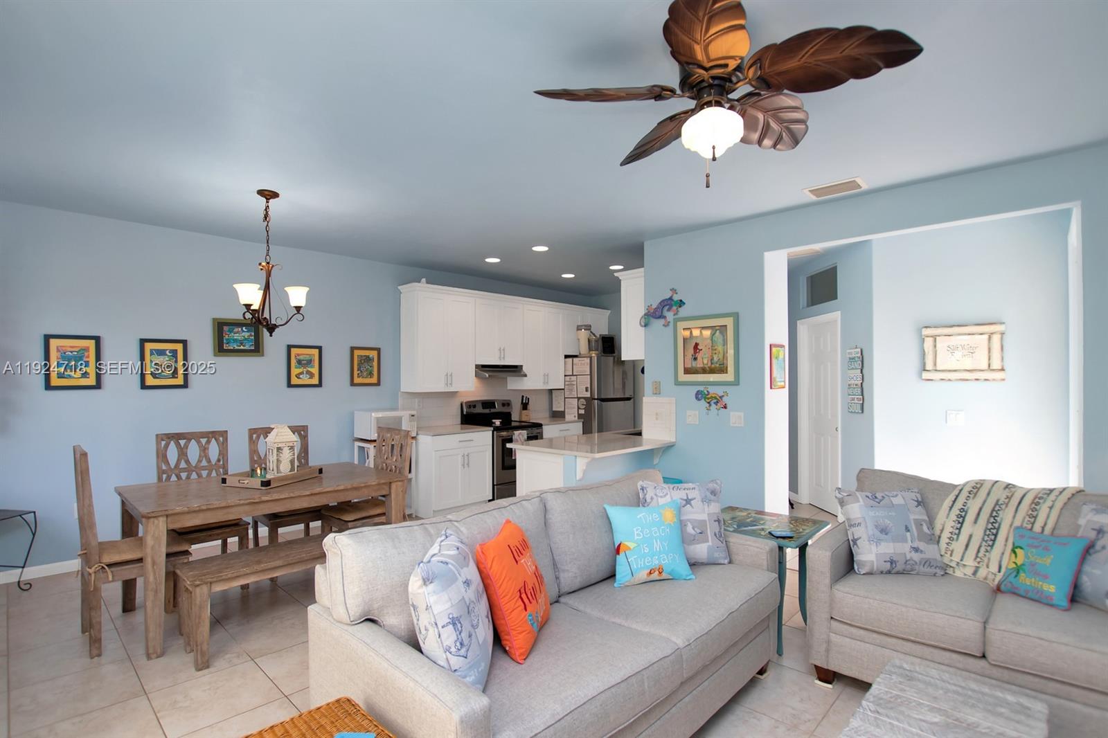 461 3rd Street Key Colony Beach, FL 33051 - Photo 11 of 79 a living room with furniture kitchen view and a chandelier