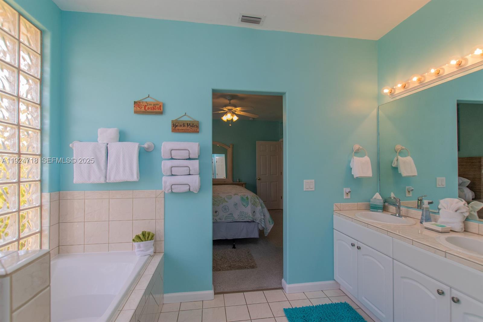461 3rd Street Key Colony Beach, FL 33051 - Photo 25 of 79 a en suite bathroom with a sink tub and mirror