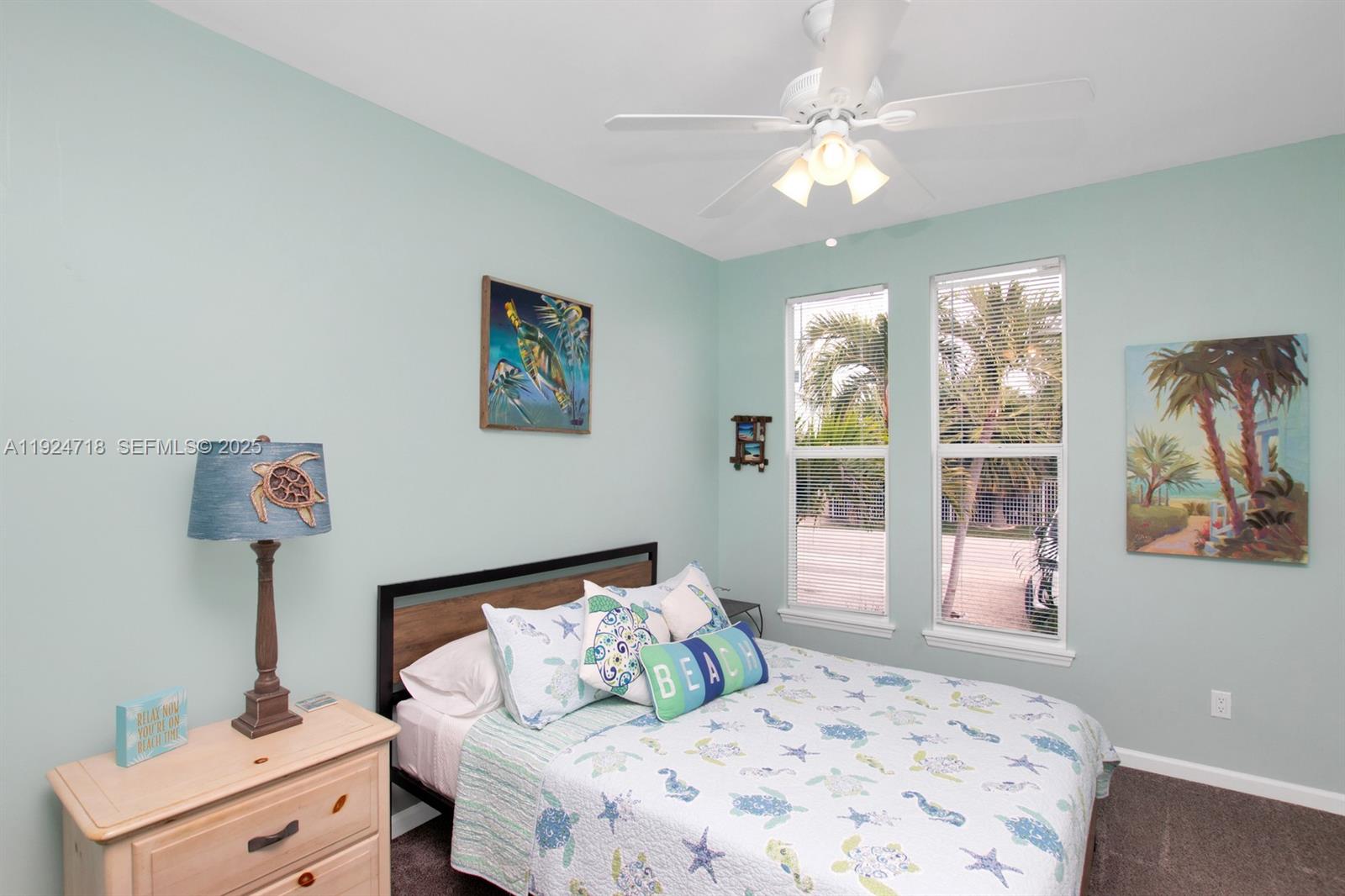 461 3rd Street Key Colony Beach, FL 33051 - Photo 28 of 79 a bedroom with a large bed and a chandelier