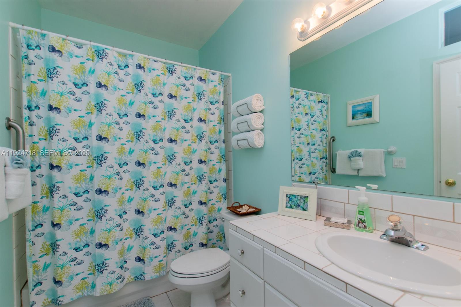 461 3rd Street Key Colony Beach, FL 33051 - Photo 31 of 79 a bathroom with a sink toilet and a mirror