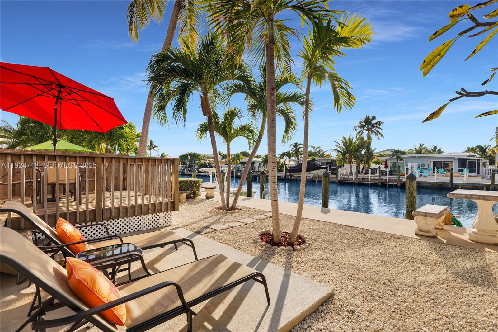 461 3rd Street Key Colony Beach, FL 33051 - Photo 40 of 79 a view of a lake with a table and chairs