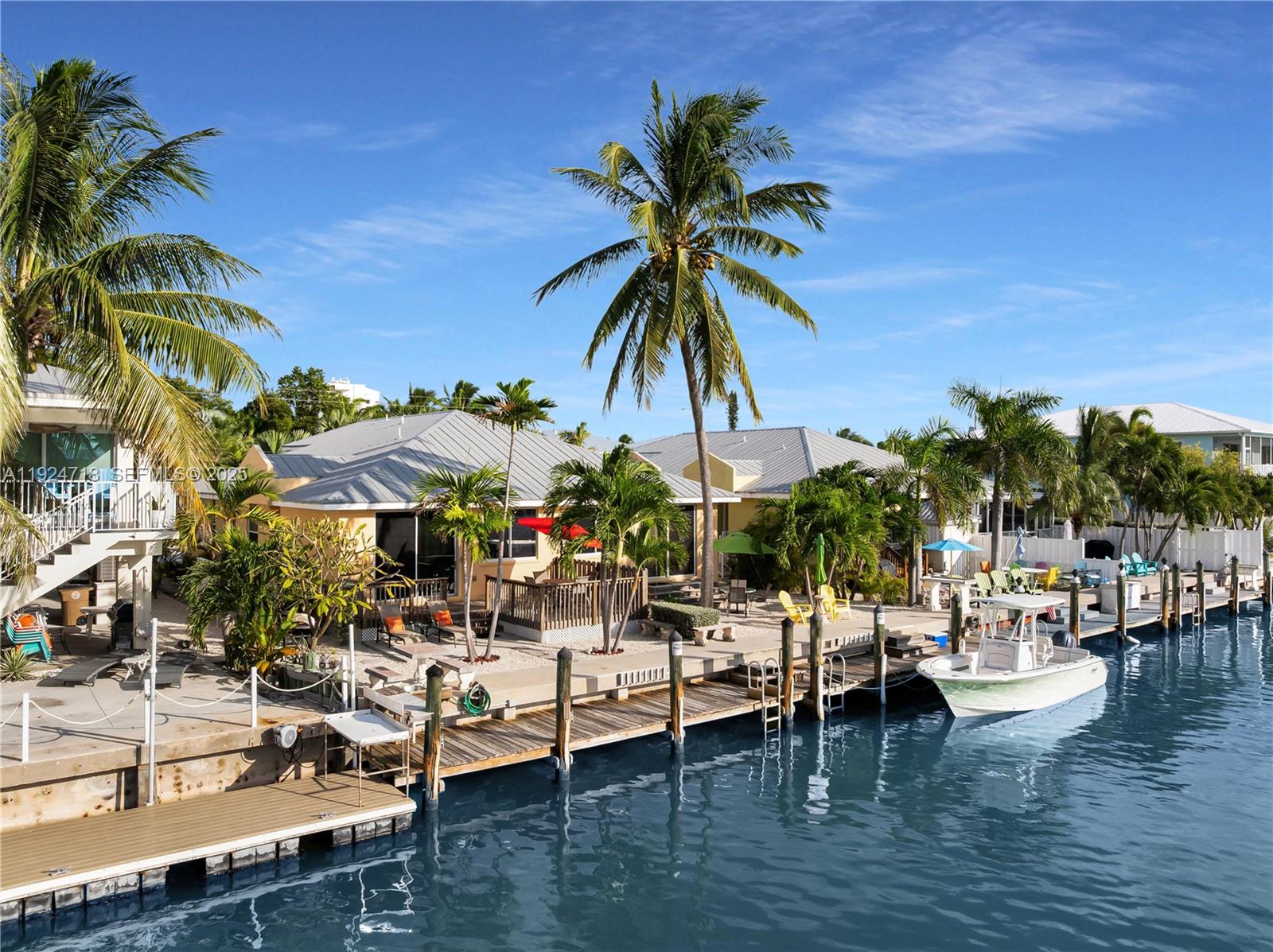 461 3rd Street Key Colony Beach, FL 33051 - Photo 42 of 79 a view of outdoor space with seating area and trees