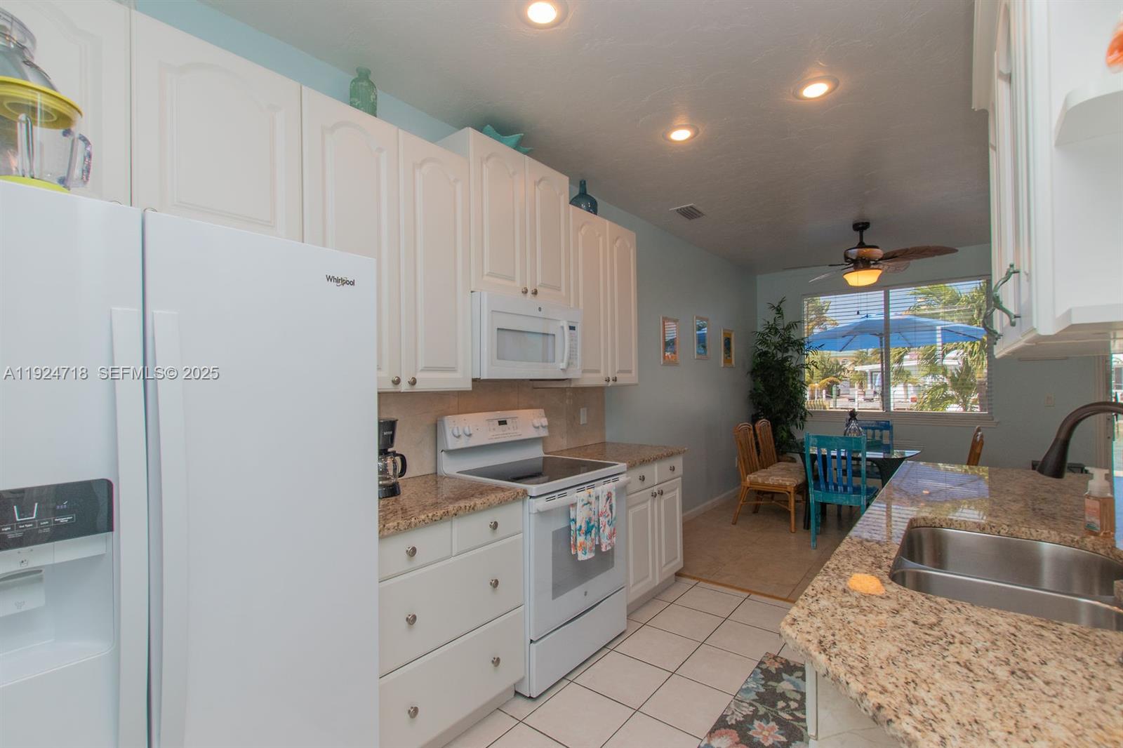 461 3rd Street Key Colony Beach, FL 33051 - Photo 56 of 79 a kitchen with white cabinets and sink