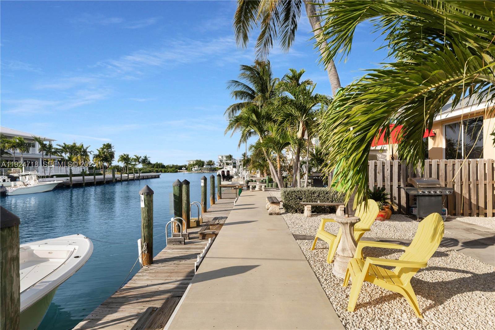 461 3rd Street Key Colony Beach, FL 33051 - Photo 6 of 79 a view of a lake with a table and chairs
