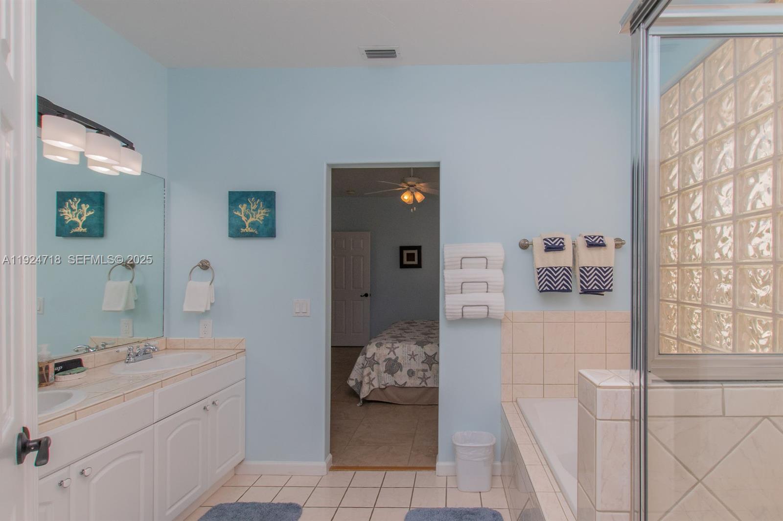 461 3rd Street Key Colony Beach, FL 33051 - Photo 61 of 79 a en suite bathroom with a sink and a mirror