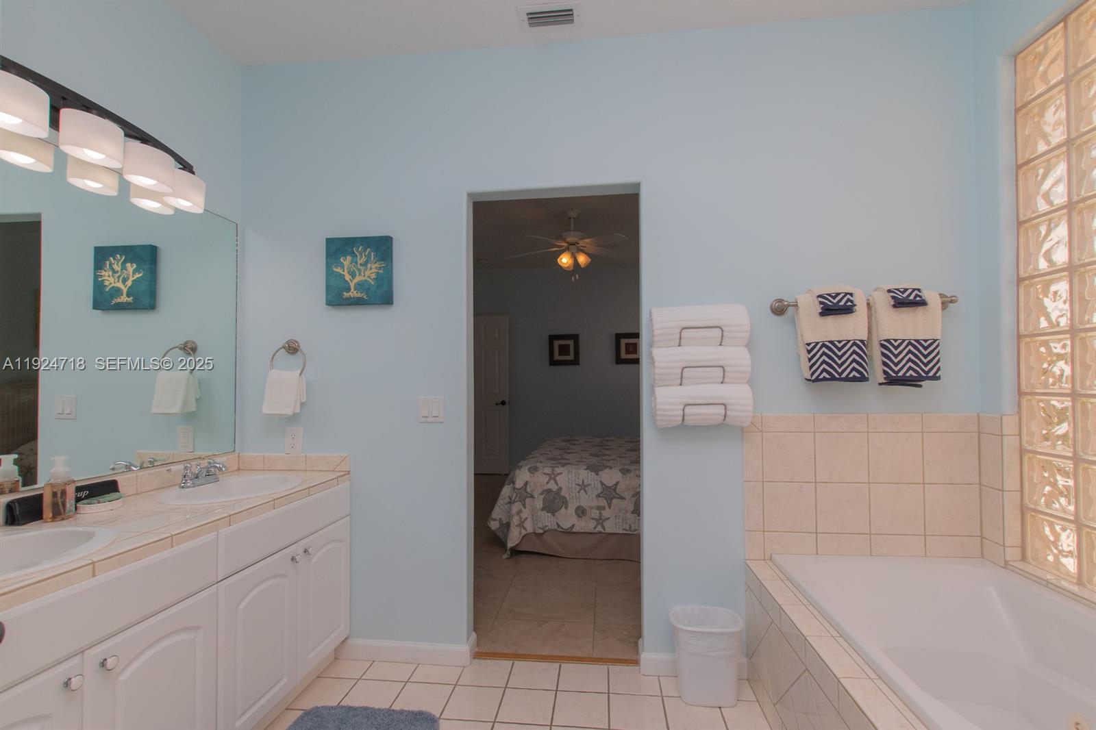 461 3rd Street Key Colony Beach, FL 33051 - Photo 62 of 79 a en suite bathroom with a tub sink and mirror
