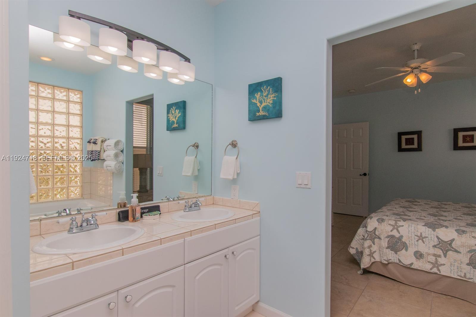 461 3rd Street Key Colony Beach, FL 33051 - Photo 63 of 79 a en suite bathroom with a sink double vanity and a mirror