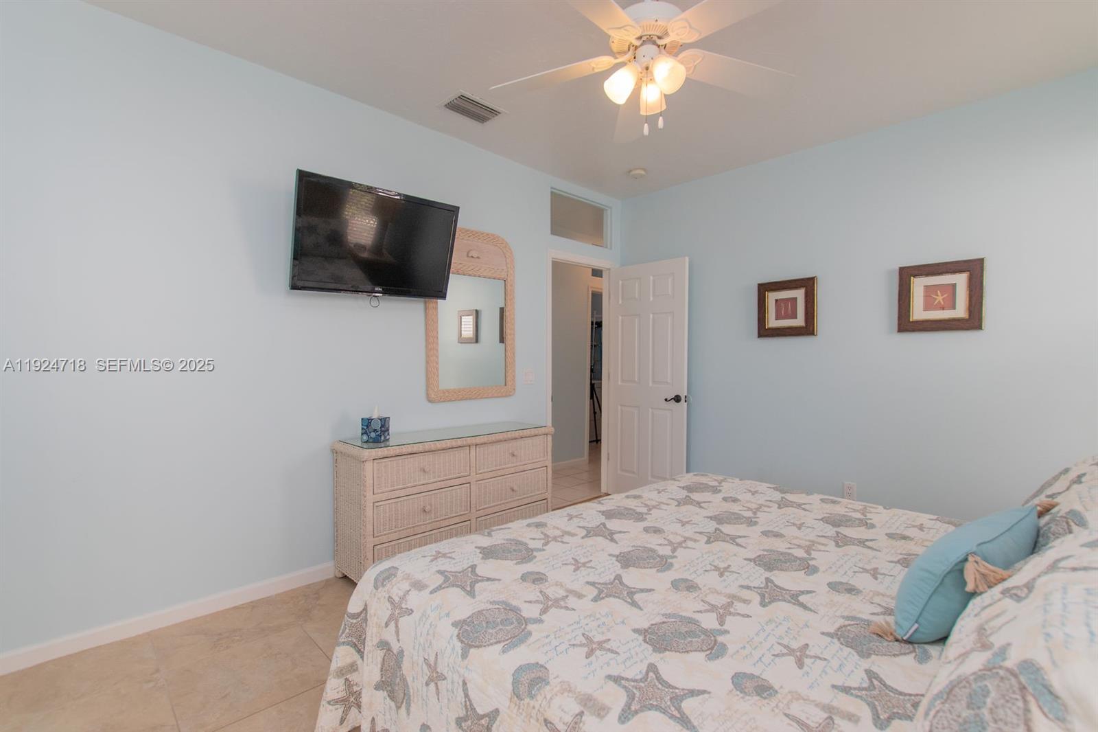 461 3rd Street Key Colony Beach, FL 33051 - Photo 65 of 79 a bedroom with a bed and a flat screen tv