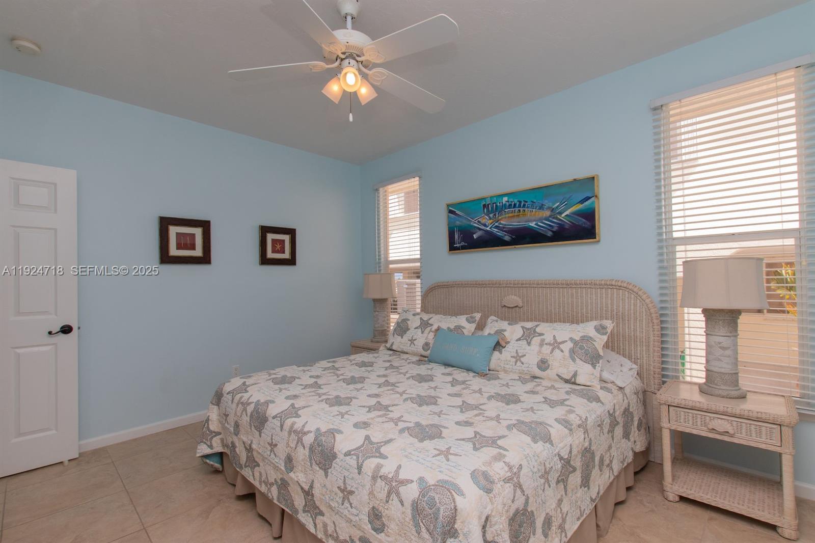461 3rd Street Key Colony Beach, FL 33051 - Photo 66 of 79 a bedroom with a bed and a painting on the wall