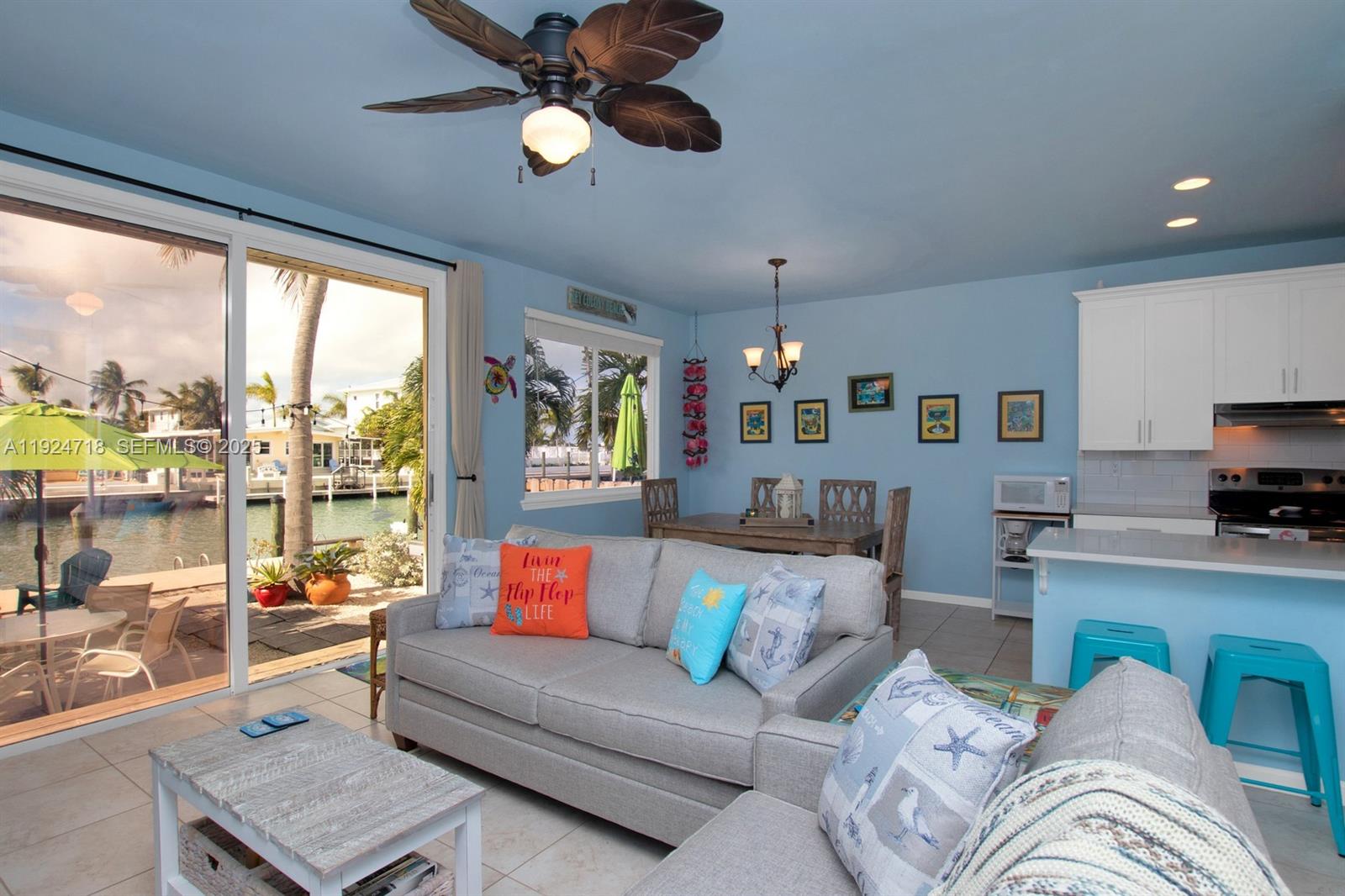 461 3rd Street Key Colony Beach, FL 33051 - Photo 9 of 79 a living room with furniture and a large window