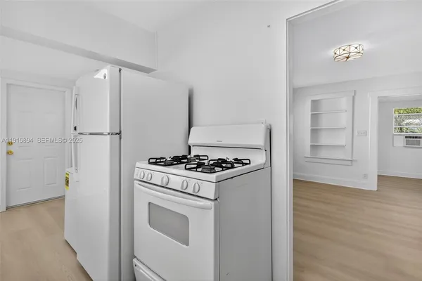 a kitchen with a stove and a refrigerator