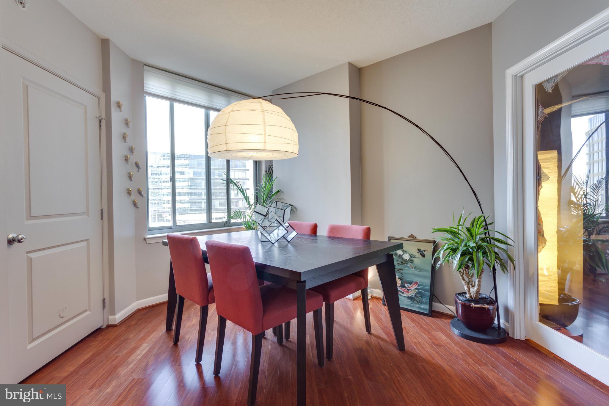 851 North Glebe Road, Unit 501 Arlington, VA 22203 - Photo 13 of 30 a view of a dining room with furniture window and wooden floor
