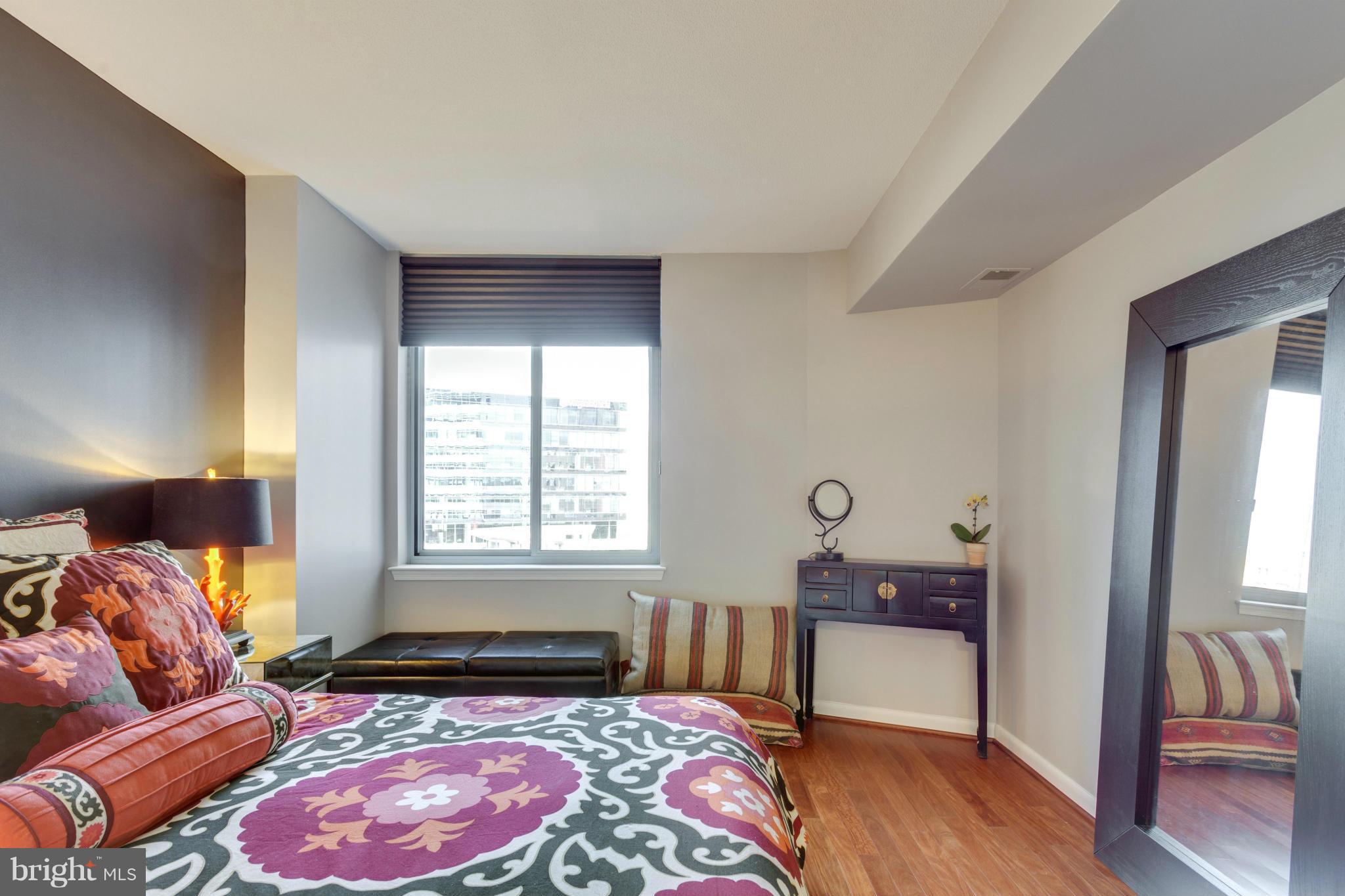 851 North Glebe Road, Unit 501 Arlington, VA 22203 - Photo 15 of 30 a bedroom with a bed and wooden floor