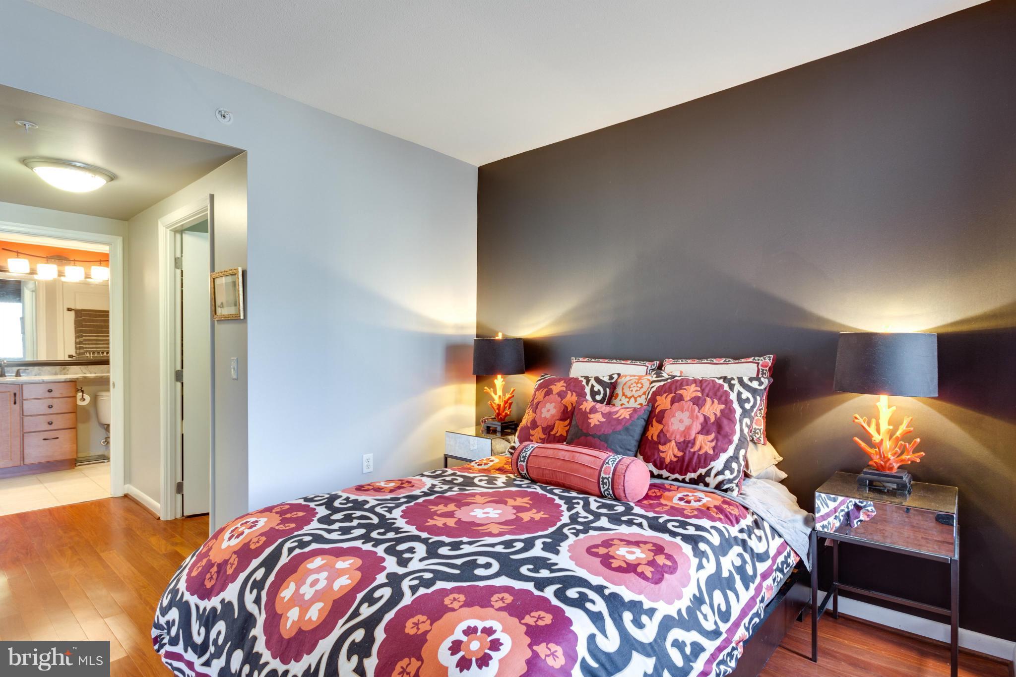 851 North Glebe Road, Unit 501 Arlington, VA 22203 - Photo 16 of 30 a bedroom with a bed and a lamp