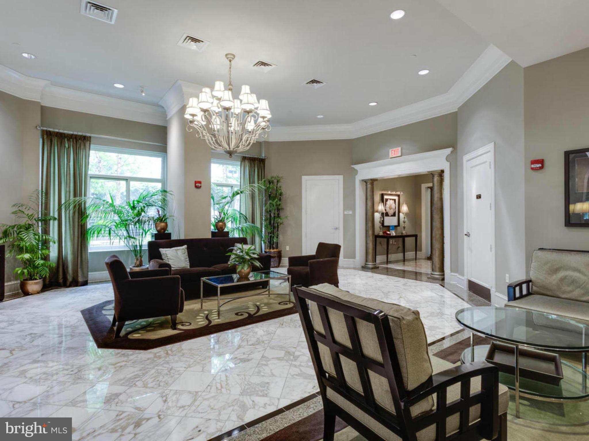 851 North Glebe Road, Unit 501 Arlington, VA 22203 - Photo 3 of 30 a living room with furniture dining table and a chandelier